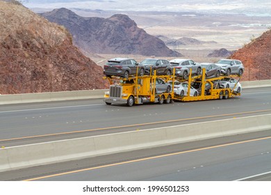 Boulder City, NV, USA - June 7, 2021: Car hauler semi truck traveling up hill on Interstate 11 in Southern Nevada near Boulder City, Nevada. 