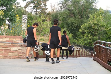 Boulder, CO USA - August 19, 2021: College Football Players Carry Their Pads And Jerseys As They Walk To Practice Outside. University Of Colorado Buffs                               