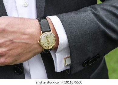 Boulder, Colorado / United States - May 10, 2015: Men's Analog Wrist Watch And Charcoal Men's Suit With White Dress Shirt And White Cuff Links 