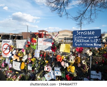 Boulder, Colorado - USA - 03 27 2021: Fence with flowers and signs after the mass shooting in King Soopers