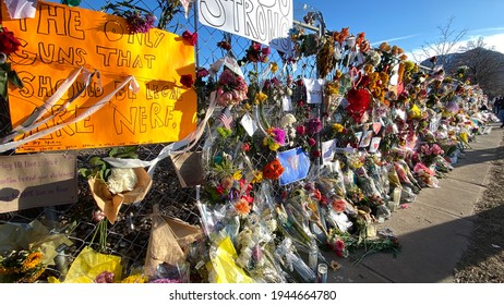 Boulder, Colorado - USA - 03 27 2021: Fence with flowers and signs after the mass shooting in King Soopers 