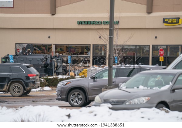 Boulder,
Colorado USA - March 22, 2021: Police and SWAT officer in front of
King Soopers - the scene of a mass
shooting