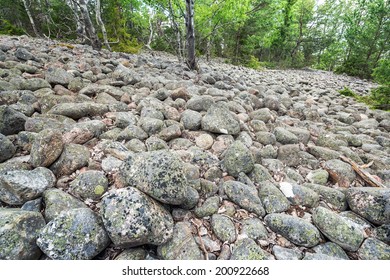 Boulder ridge or esker with round boulders of granite, Sweden - Shutterstock ID 200922668