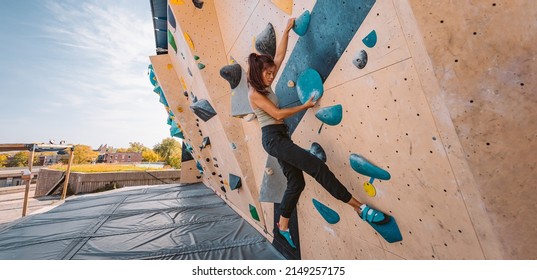 Bouldering Climbing Athlete Woman Training Strength At Outdoor Gym Boulder Climb Wall. Asian Fit Girl Going Up Having Fun In Extreme Sport Hobby. Banner Panoramic