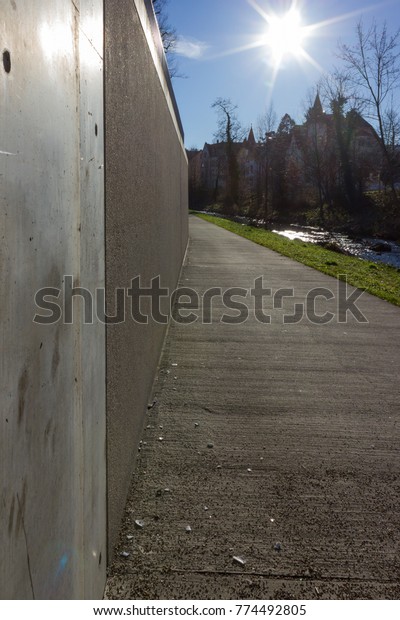 boulevard on a riverside with bridge\
and concrete elements in december christmas advent in south germany\
blue sunny day near city of munich and\
stuttgart