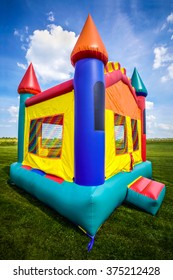 Bounce House Inflatable Jumpy Castle In A Large Open Yard.