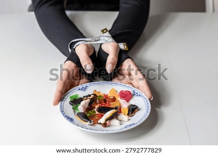Bound hands resisting sweets during weight loss