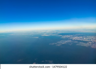 The boundaries of the Earth's atmosphere between the troposphere and the stratosphere show clouds that are at the top of the troposphere and the blue sky.
