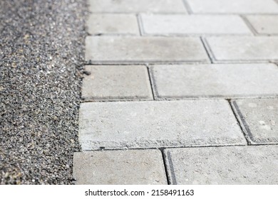 The Boundary Between The Mulch Rubber Playground And The Sidewalk Tiles.