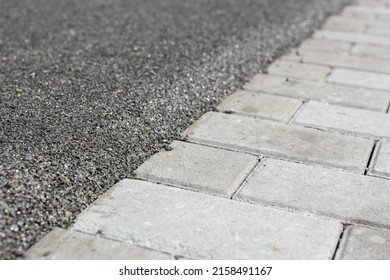 The Boundary Between The Mulch Rubber Playground And The Sidewalk Tiles.