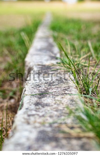 Boundary line in lawn made\
of limestone