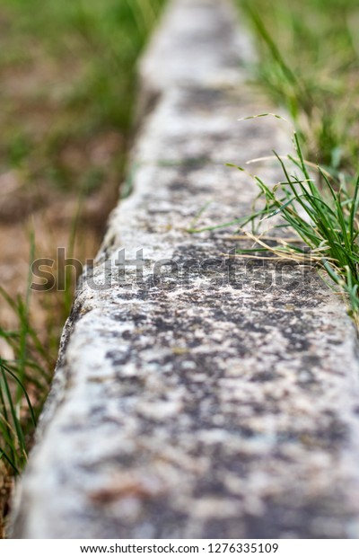 Boundary line in lawn made
of limestone