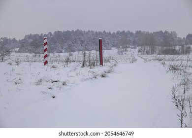 Boundary Pillars Of Belarus And Poland On The Border In A Winter Field