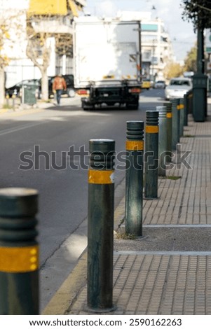 Boundary posts between the sidewalk and the highway. Parking restrictions
