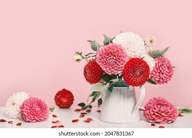 Bouquet of beautiful dahlias flowers and petals on white table. Autumn festive decoration, trendy shadows