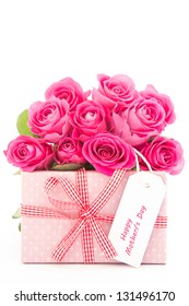 Bouquet Of Beautiful Pink Roses Next To A Pink Gift With A Happy Mothers Day Card On White Background Close Up