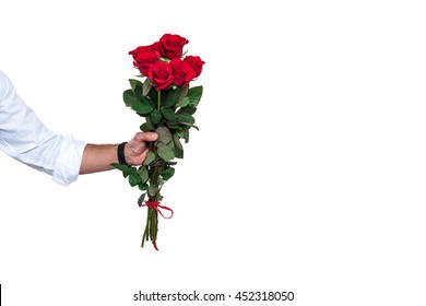 Bouquet Of Beautiful Roses. Cropped Shot Of A Young Man's Arm Holding Out A Bunch Of Red Roses