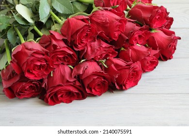 Bouquet Of Big Red Roses On Gray Wooden Table. Top Down View. Closeup