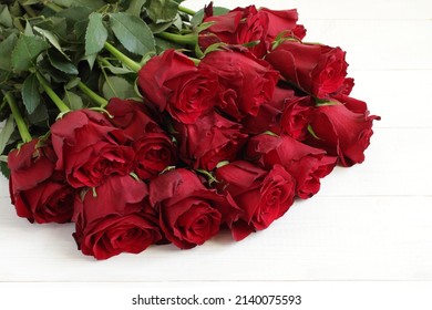 Bouquet Of Big Red Roses On White Wooden Table. Top Down View. Closeup