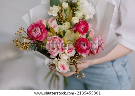 Bouquet for the bride in female hands. Flowers for the wedding. Leukadendron, ranunculus, genista. Tulips, roses, carnation shabot. Gift on the 8 march. Plans for valentines day.