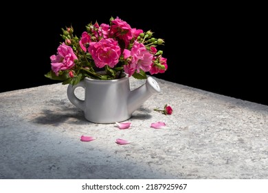 Bouquet of bright pink roses in ceramic watering can. Black background. On table with loose heterogeneous stone texture . - Shutterstock ID 2187925967