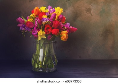 bouquet of bright spring flowers in vase on black background, retro toned - Powered by Shutterstock