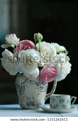 Similar – Woman makes festive bouquet with vase