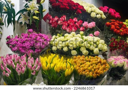 Bouquet of colorful roses, Eustoma, Tulip, other different flowers at entrance flower store. Showcase. Beautiful flowers for catalog, online store. Flower business. Concept flower store and delivery.
