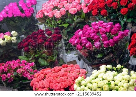 Bouquet of colorful roses and other different flowers at the entrance of the flower store. Showcase. Beautiful flowers for a catalog, online store. Flower business. Сoncept flower store and delivery.