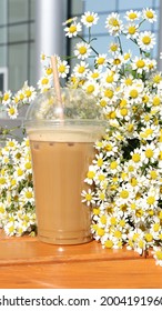 A Bouquet Of Daisies With Cold Coffee