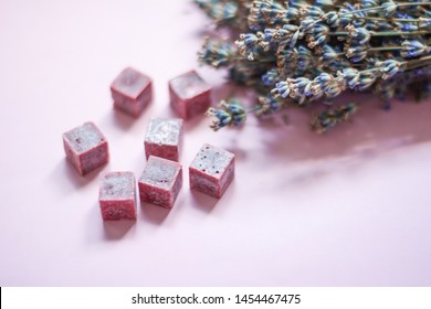 Bouquet Of Dried Lavender And Aroma Purple Lilac Wax Cubes Candles Lying On Pink Background, Aromatherapy, Close Up, Copy Space