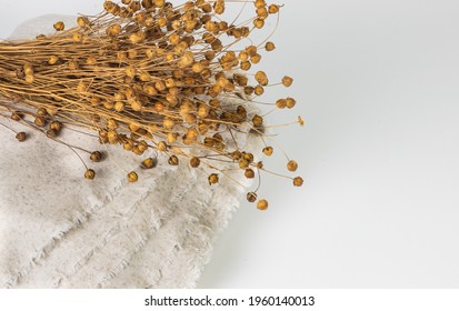 Bouquet Of Dry Flax Plants With Flaxseed Capsules On Linen Cloth.