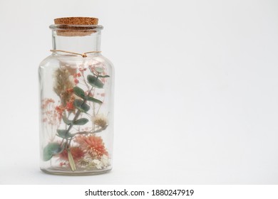 bouquet of dry flowers and potpourri in a glass jar on a white table. High quality photo - Powered by Shutterstock