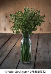 Bouquet Of Eared Wild Herbs In A Tall Glass Vase