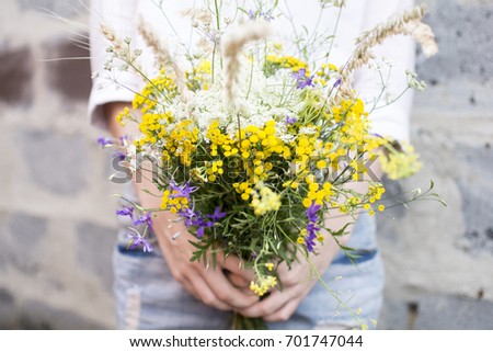 Similar – Female hands holding flower vase with wild flowers