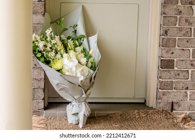 A Bouquet Of Flowers Delivered On A Porch Doorsteps Of A House Front Door. Surprise Contactless Delivery. Mother's Day, Valentine's Day, Birthday, Anniversary And Celebration