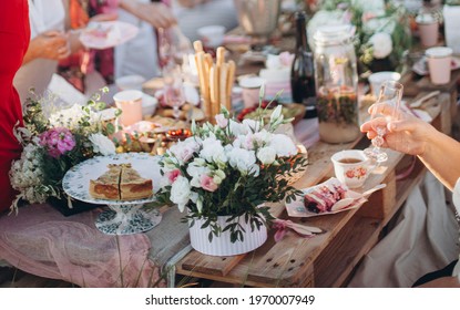 a bouquet of flowers on a table from pallets. celebrating with friends and family in a park or garden. outdoor picnic. festive boho wedding table	
 - Powered by Shutterstock