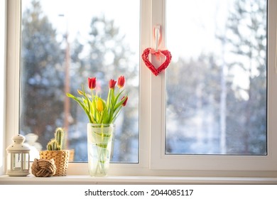 A Bouquet Of Flowers Is On The Window. Outside The Window, A Sunny Frosty Snowy Morning