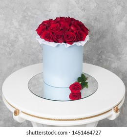 Bouquet Of Flowers In A Round Hat Box On A White Table