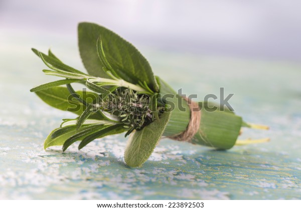 Bouquet of fresh herbs, tied with twine.\
Rosemary, thyme, oregano,\
parsley