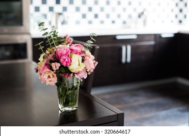 Bouquet Of Fresh Pink Flowers On The Dining Table In The Interior Of Modern Kitchen