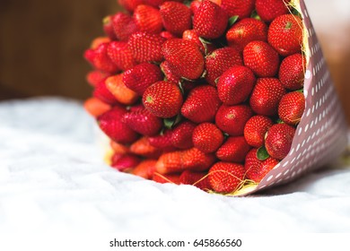 a bouquet of fruit, strawberries and blackberries