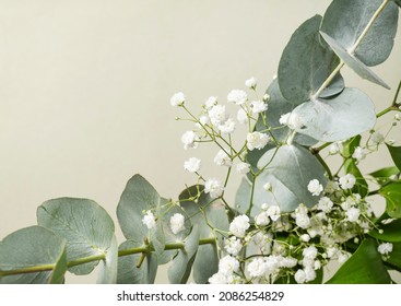 Bouquet Of Gypsophila And Eucalyptus On A Green Background. The Concept Of A Holiday Or Gift Card. Top View And Copy Space.