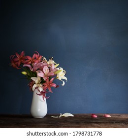 Bouquet Of Lily Flowers In Vase On Dark Background