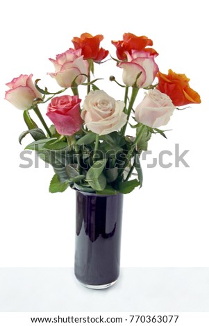 bouquet of multicolor rose in purple wase