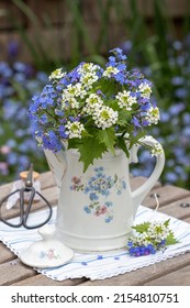 Bouquet Of Navelwort And Hedge Garlic In Vintage Coffee Can