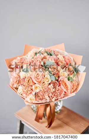 Bouquet Peach and orange color. Beautiful bunch mixed flowers in wooden table. the work of the florist at a flower shop. Fresh cut flower.