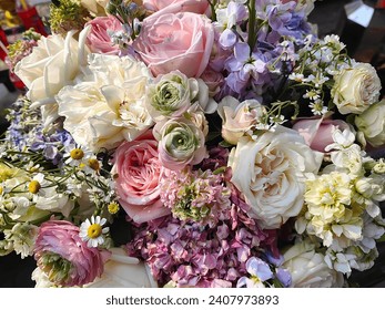 A bouquet of pink roses, white roses, purple daisies and many other beautiful colors. A bouquet  for background - Powered by Shutterstock