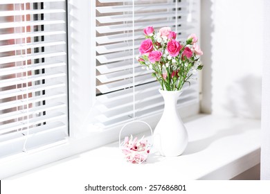 Bouquet of pink roses in white vase on windowsill background - Powered by Shutterstock