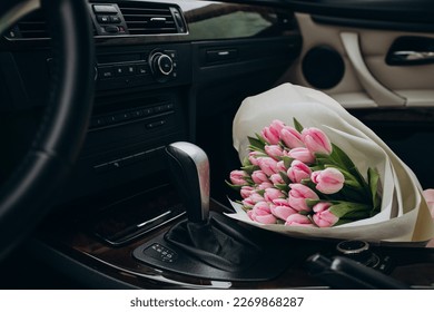 Bouquet of pink tulips lying in car - Shutterstock ID 2269868287